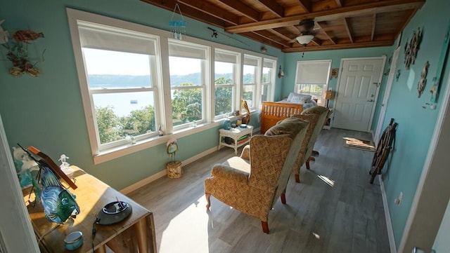 interior space featuring hardwood / wood-style floors, beamed ceiling, and wood ceiling