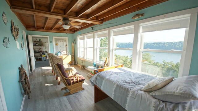 bedroom with wood ceiling, beamed ceiling, and hardwood / wood-style flooring