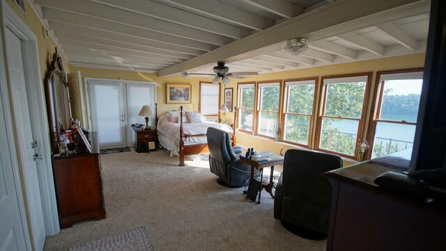 sunroom / solarium featuring beamed ceiling and ceiling fan