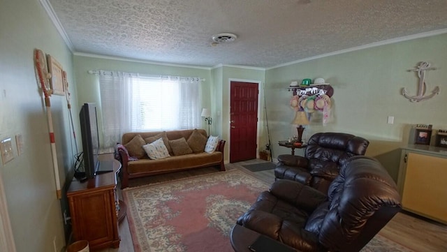 living room featuring a textured ceiling, crown molding, and hardwood / wood-style floors