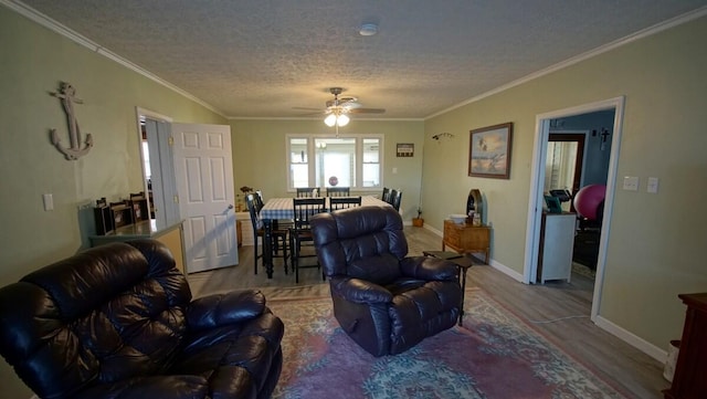 living room with ceiling fan, crown molding, hardwood / wood-style floors, and a textured ceiling