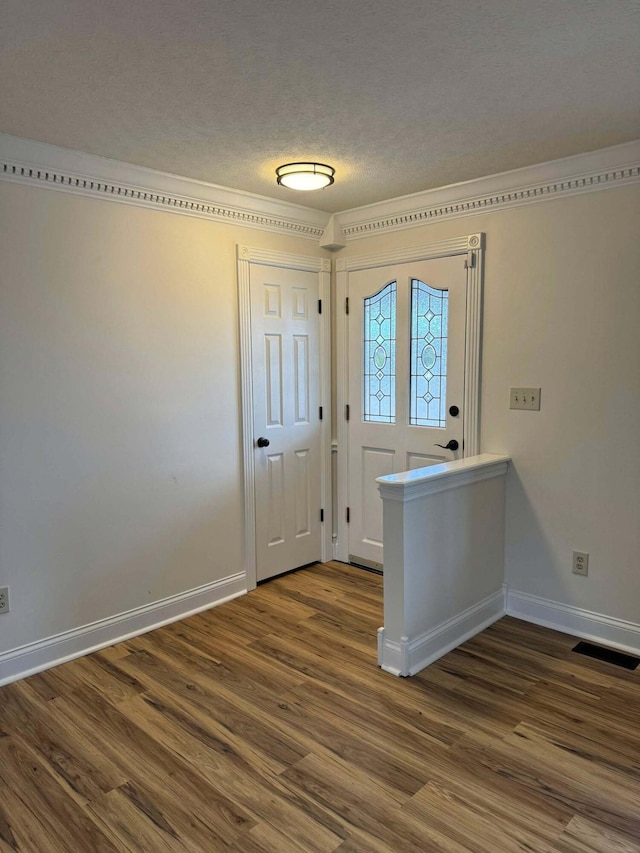 entrance foyer featuring dark hardwood / wood-style floors and a textured ceiling