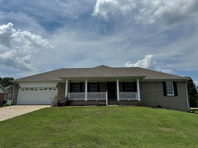 ranch-style home featuring a porch, a garage, and a front lawn