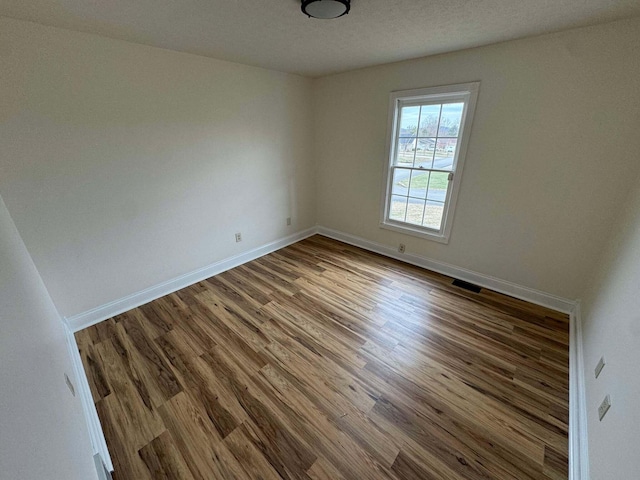 empty room with wood-type flooring