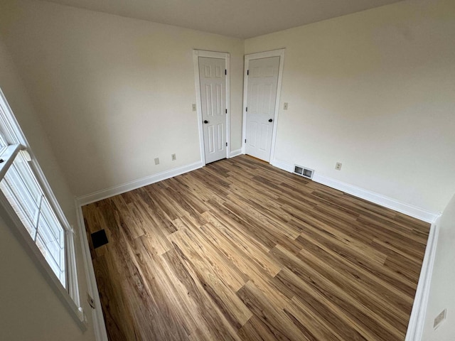 unfurnished room featuring dark hardwood / wood-style flooring