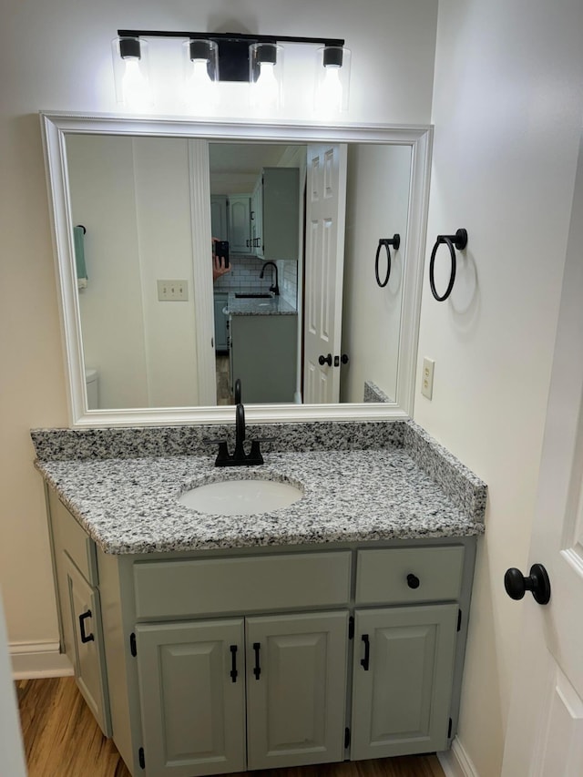 bathroom with vanity and hardwood / wood-style floors