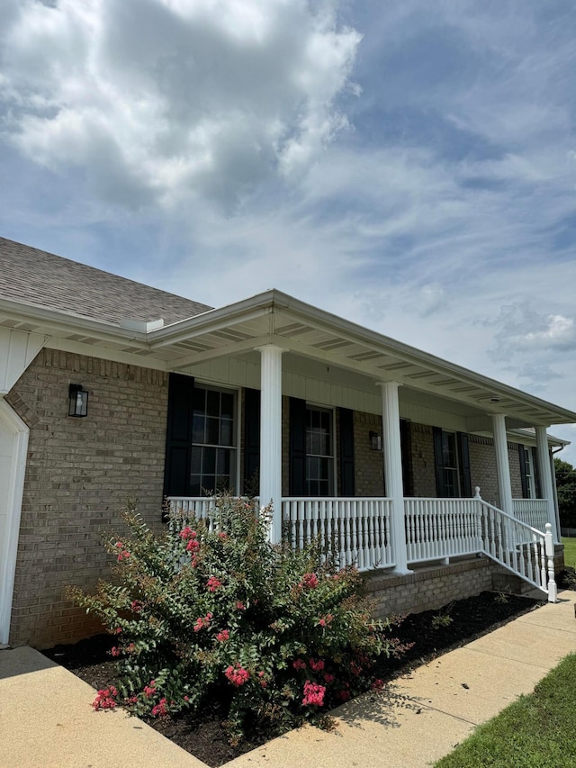 view of property exterior featuring covered porch