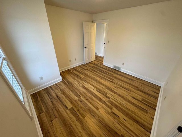 unfurnished room with hardwood / wood-style floors