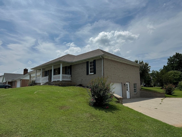 view of home's exterior featuring a garage, a porch, and a lawn