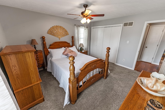 bedroom featuring dark colored carpet, a closet, and ceiling fan