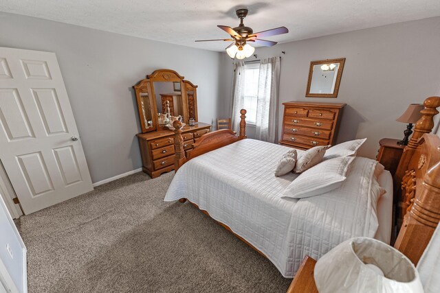 carpeted bedroom with a textured ceiling and ceiling fan