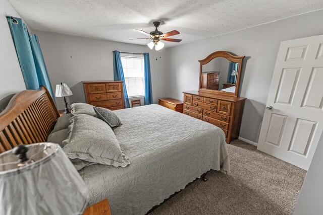 carpeted bedroom featuring a textured ceiling and ceiling fan