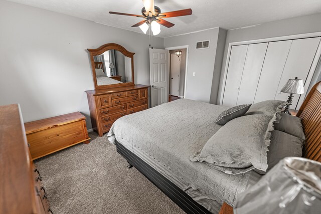 bedroom with carpet, ceiling fan, and a closet