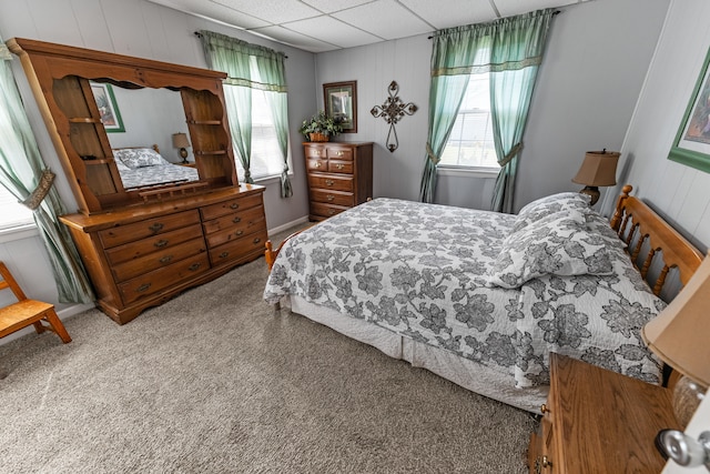 bedroom featuring carpet floors and a paneled ceiling