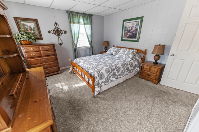 bedroom featuring a paneled ceiling and carpet flooring