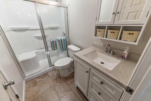 bathroom with tile patterned flooring, toilet, vanity, and an enclosed shower