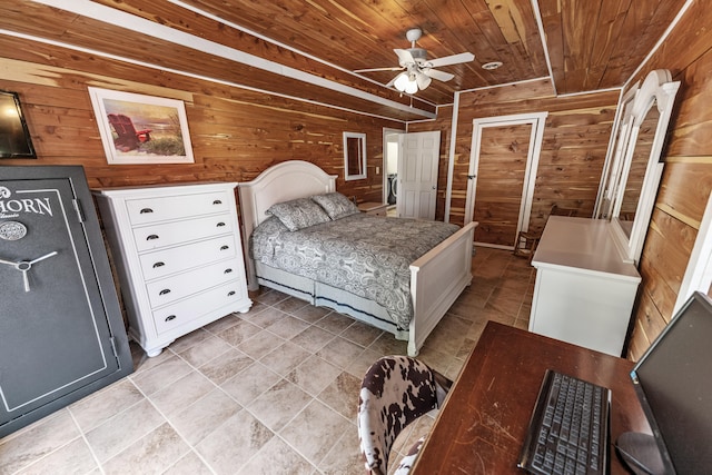 bedroom featuring ceiling fan, light tile patterned floors, wooden walls, and wood ceiling