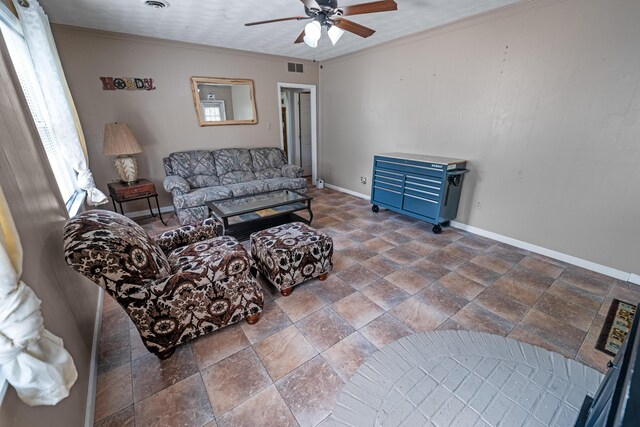 living room featuring tile patterned flooring, ceiling fan, and ornamental molding