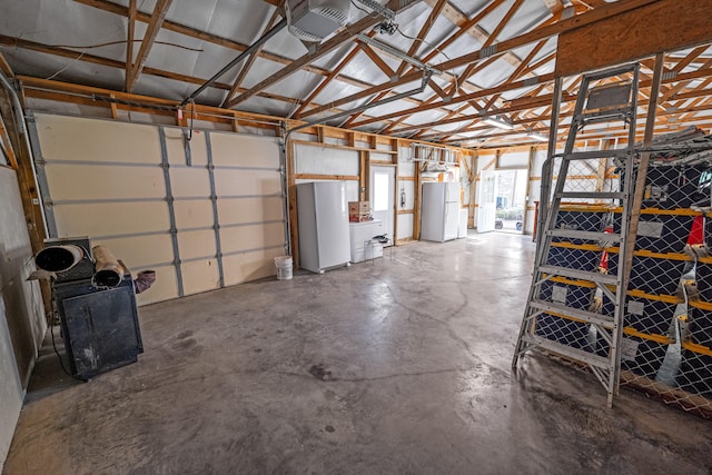 garage featuring white fridge and fridge