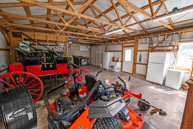 garage with water heater and white fridge