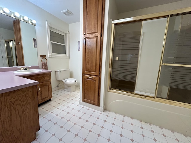 full bathroom with toilet, combined bath / shower with glass door, and vanity