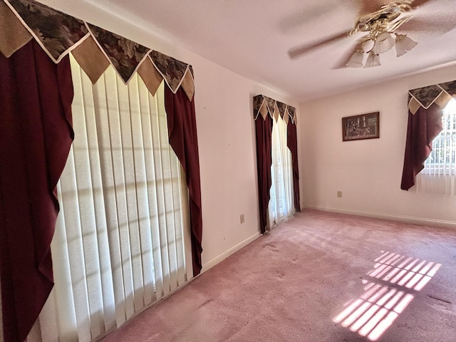 spare room featuring carpet flooring and ceiling fan