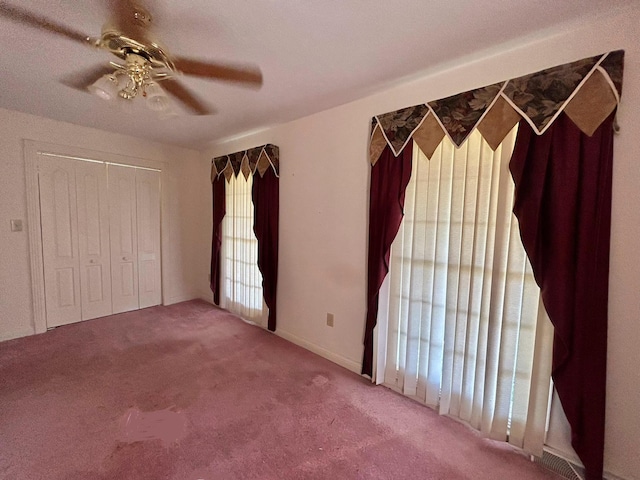 unfurnished bedroom featuring a closet, ceiling fan, and carpet floors