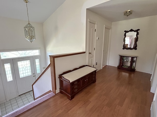 foyer entrance with a notable chandelier and hardwood / wood-style floors