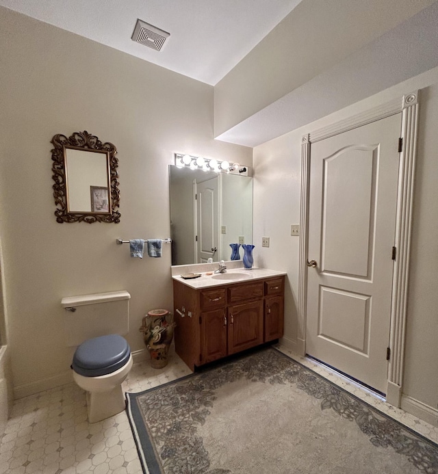 bathroom with toilet and vanity