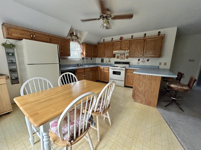 kitchen featuring sink, vaulted ceiling, white appliances, ceiling fan, and kitchen peninsula