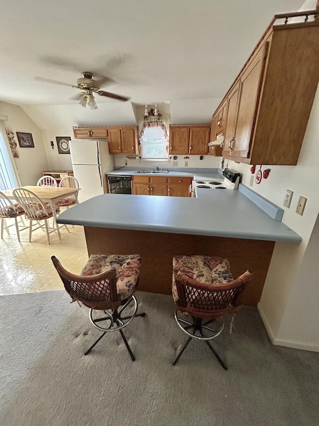 kitchen with white appliances, kitchen peninsula, lofted ceiling, ceiling fan, and light carpet