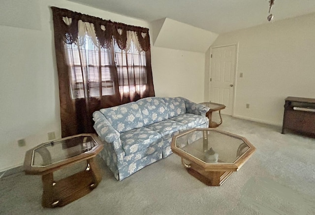 carpeted living room featuring lofted ceiling