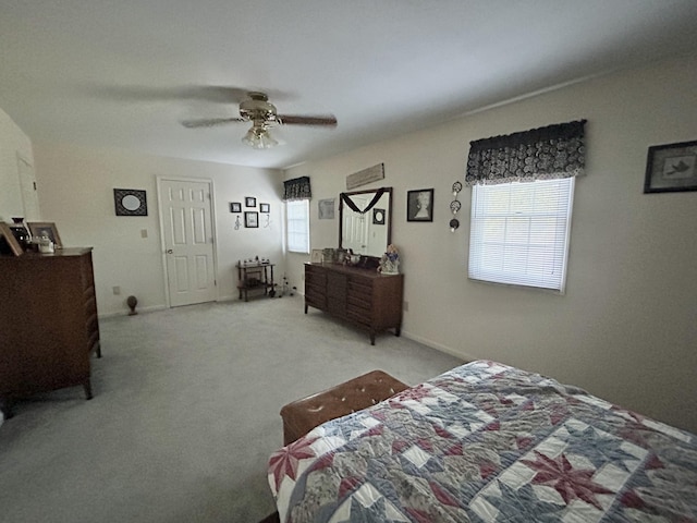 carpeted bedroom with multiple windows and ceiling fan