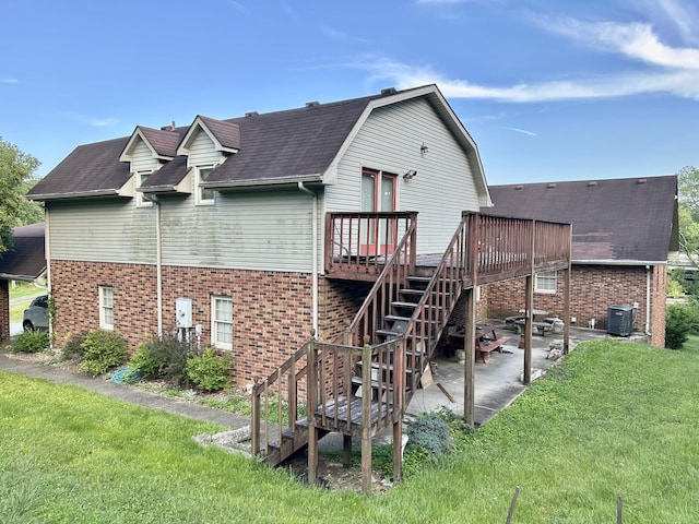 rear view of property featuring a patio, a lawn, central AC, and a wooden deck