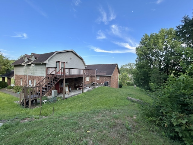 back of house with a patio, a yard, and a wooden deck