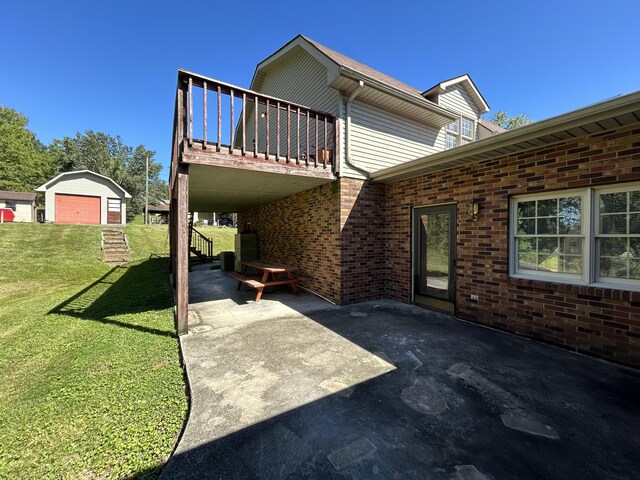 view of patio with a balcony and an outdoor structure