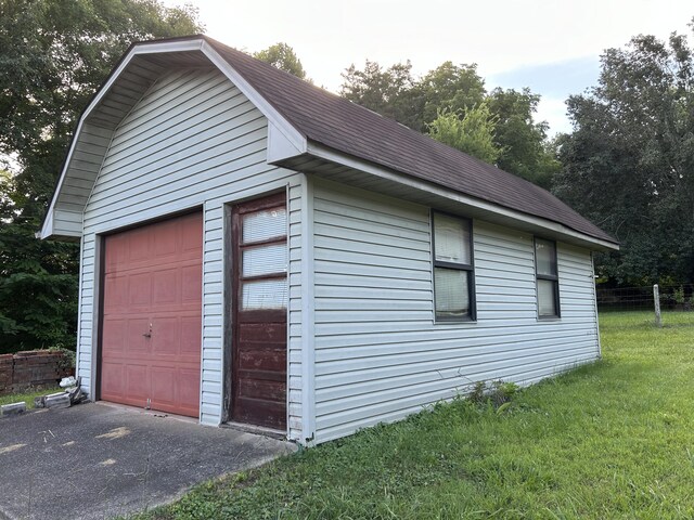 garage featuring a lawn