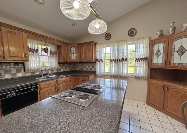 kitchen with dishwasher, stainless steel gas stovetop, decorative backsplash, sink, and lofted ceiling