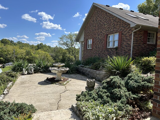 view of side of property featuring a patio area