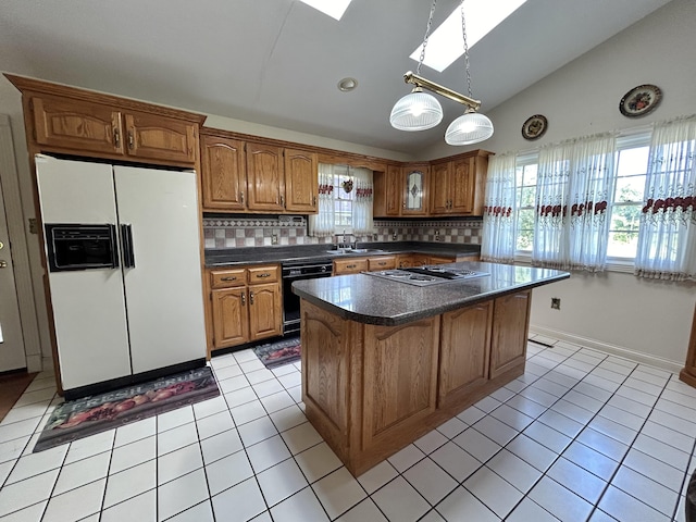 kitchen with sink, dishwasher, decorative backsplash, vaulted ceiling with skylight, and white fridge with ice dispenser