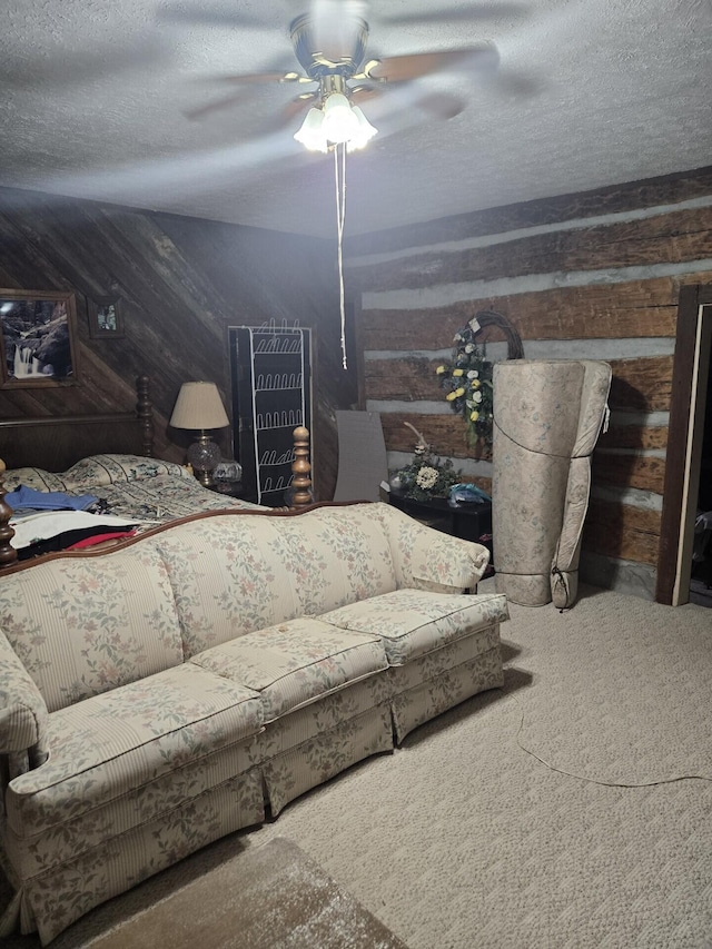 carpeted bedroom with wood walls, a ceiling fan, and a textured ceiling