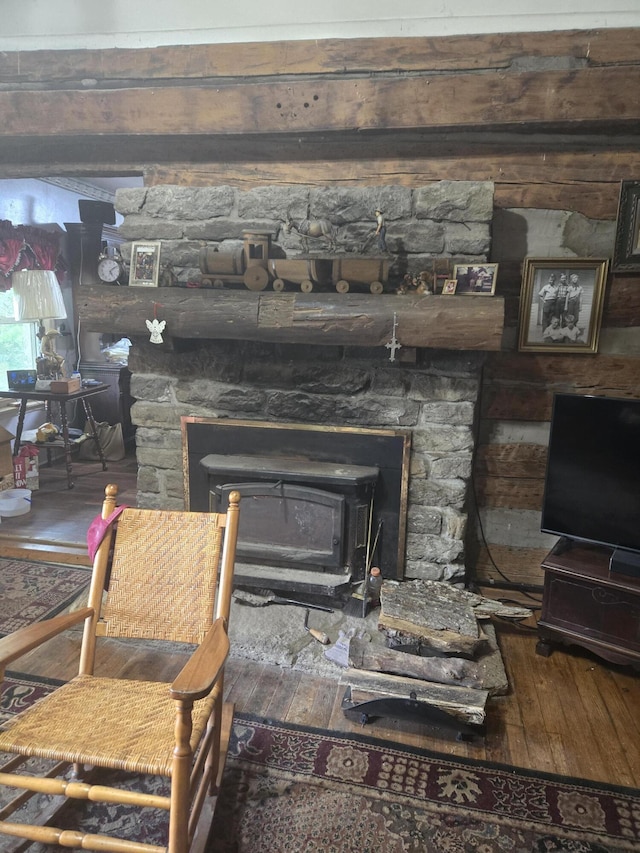 room details featuring a wood stove and wood finished floors