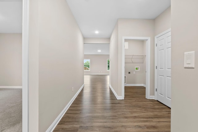 hall with dark wood-type flooring