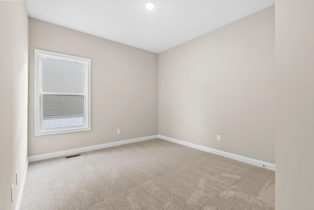 empty room with light colored carpet