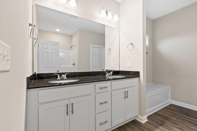 bathroom with a shower, vanity, and hardwood / wood-style floors