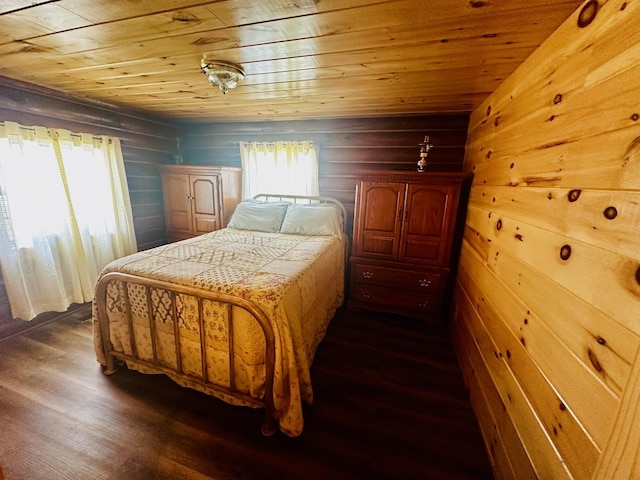 bedroom with dark hardwood / wood-style floors, wood walls, and wooden ceiling