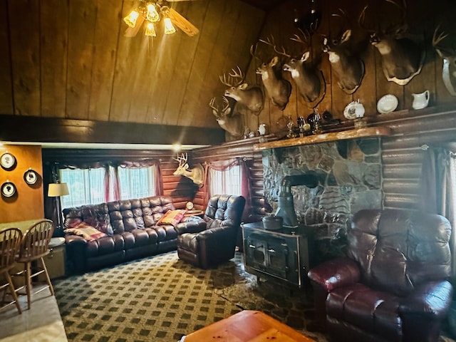 living room featuring rustic walls, wood walls, and ceiling fan