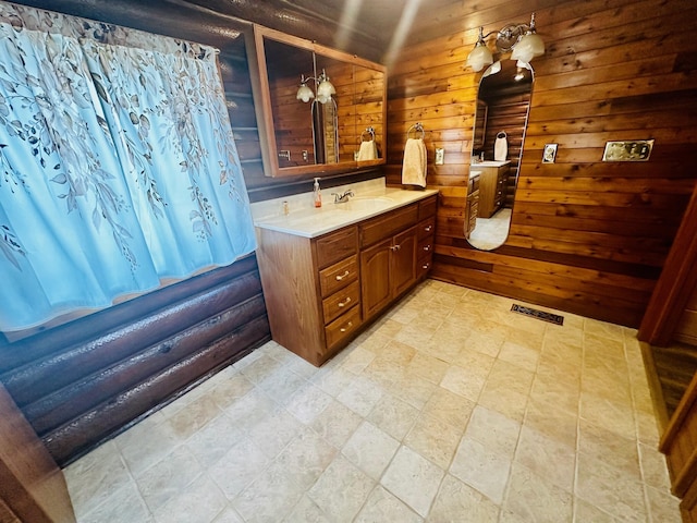 bathroom featuring wood walls and vanity