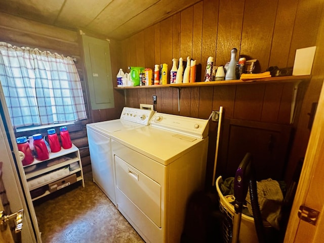 laundry area featuring washer and clothes dryer and wooden walls