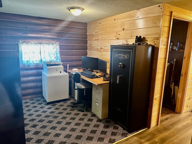 home office featuring a textured ceiling and wood walls